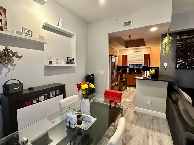 dining space featuring light hardwood / wood-style floors and sink