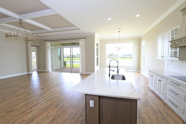 kitchen featuring white cabinets, decorative light fixtures, and dark wood-type flooring