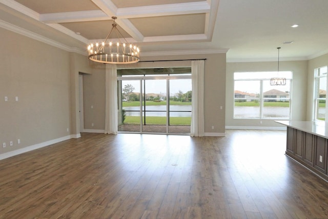 empty room featuring hardwood / wood-style floors, a water view, and crown molding