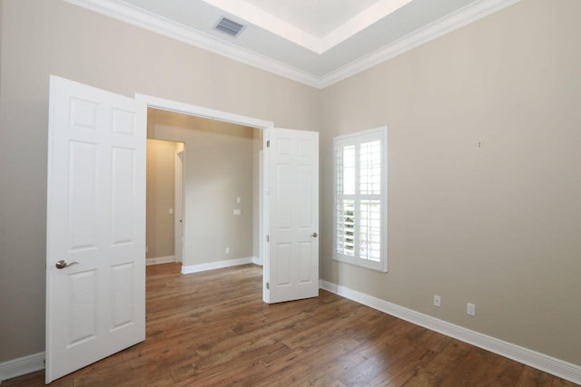 unfurnished bedroom with dark hardwood / wood-style floors and ornamental molding