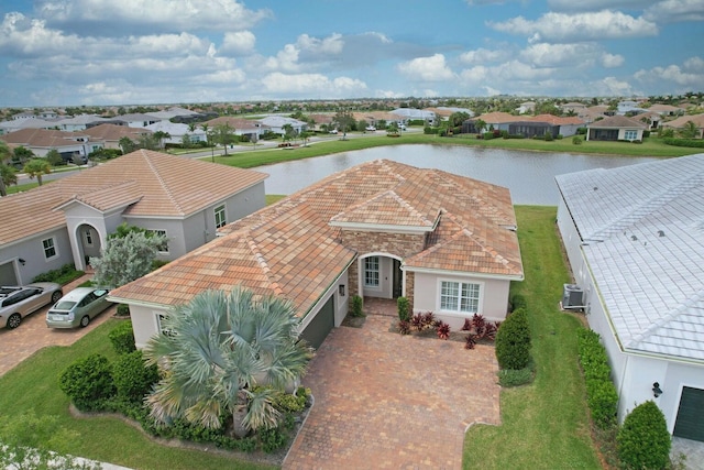 birds eye view of property with a water view