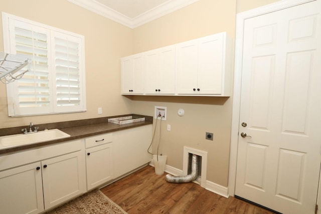 washroom featuring cabinets, washer hookup, hookup for an electric dryer, dark hardwood / wood-style flooring, and crown molding