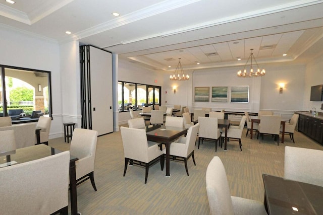 carpeted dining area with a chandelier, crown molding, and a tray ceiling