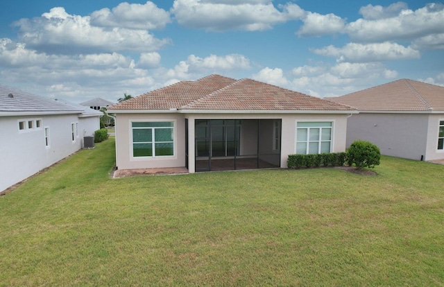 back of house featuring a lawn and central AC