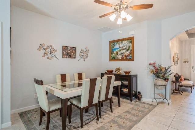 tiled dining room with ceiling fan