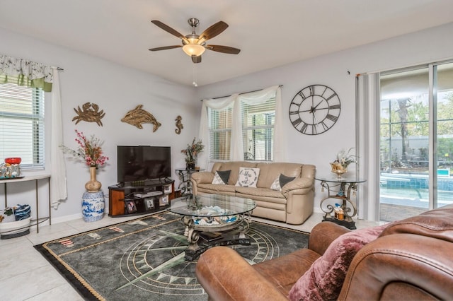 tiled living room featuring a wealth of natural light and ceiling fan