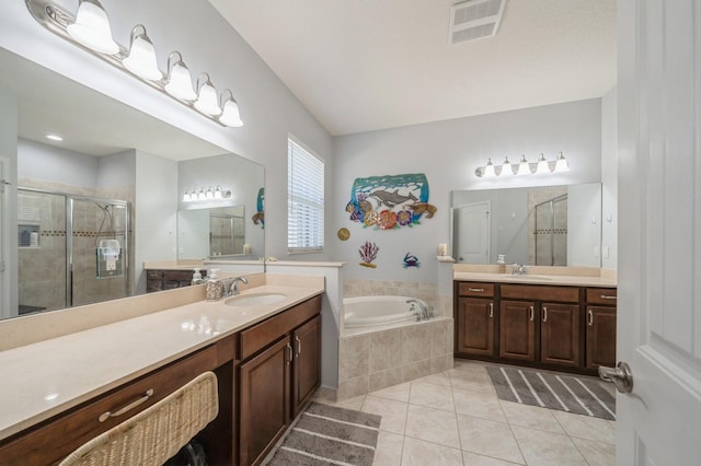 bathroom featuring shower with separate bathtub, vanity, and tile patterned floors