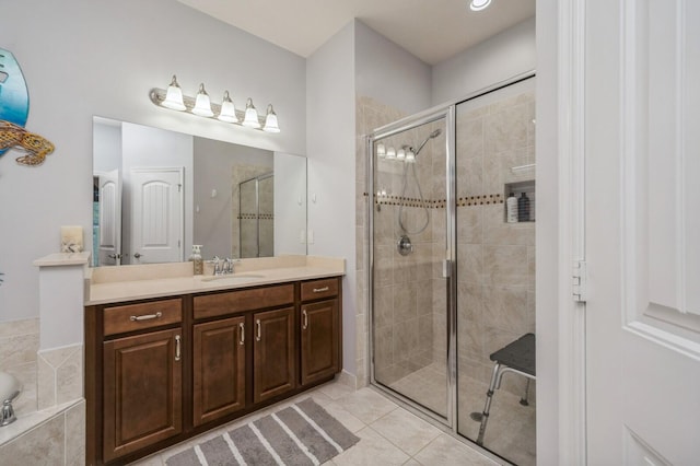 bathroom featuring vanity, plus walk in shower, and tile patterned flooring