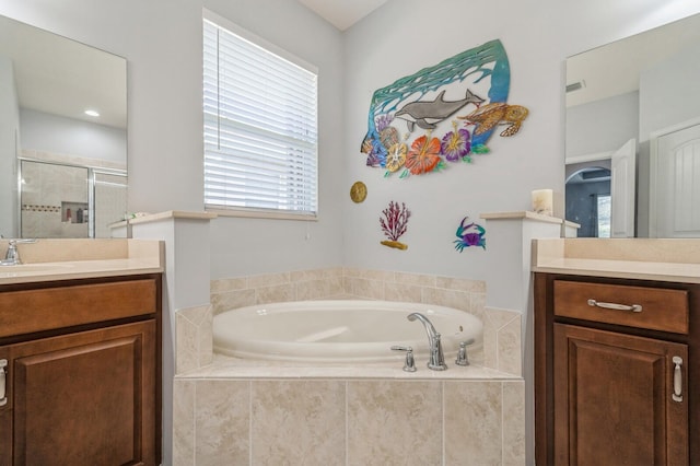 bathroom featuring vanity and separate shower and tub