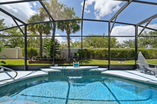 view of pool with a lanai, a patio, and pool water feature