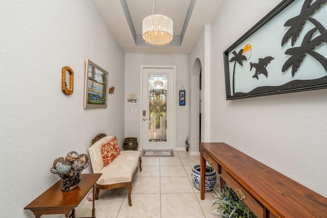 tiled foyer featuring a chandelier