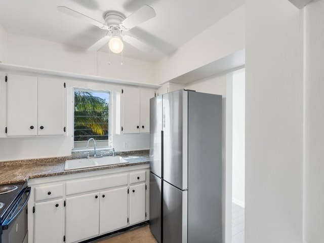 kitchen featuring stainless steel fridge, ceiling fan, sink, white cabinets, and black electric range oven