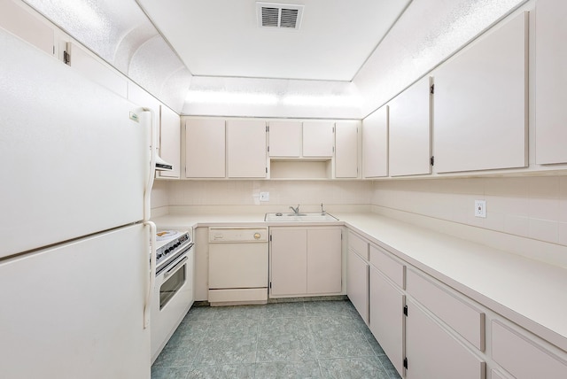 kitchen with light tile patterned flooring, white cabinetry, backsplash, sink, and white appliances