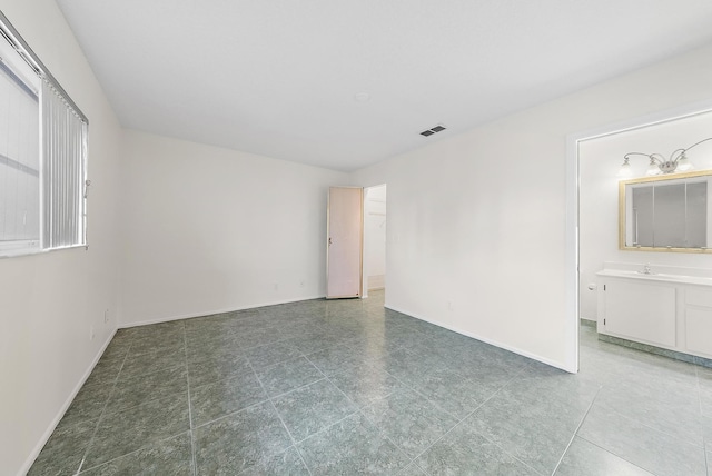 unfurnished room with sink