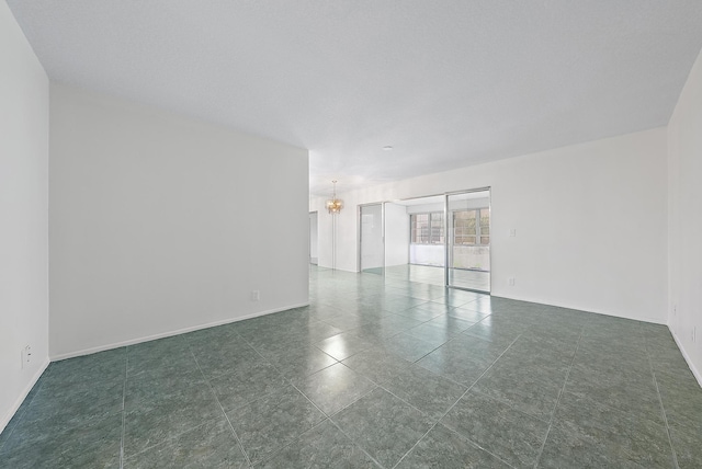 spare room with a notable chandelier