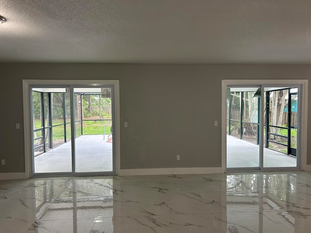 unfurnished room featuring a textured ceiling