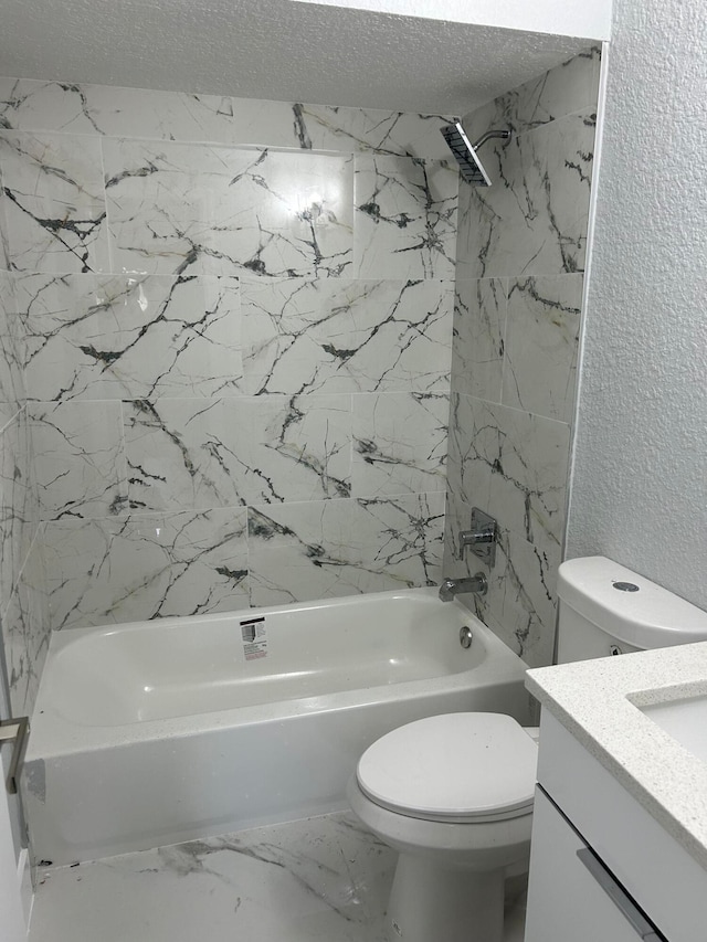 full bathroom featuring a textured ceiling, vanity, tiled shower / bath combo, and toilet