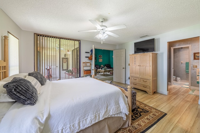 bedroom with multiple windows, ceiling fan, light wood-style flooring, and a textured ceiling