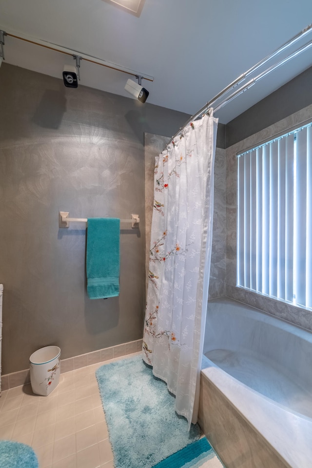 bathroom with tile patterned flooring and baseboards