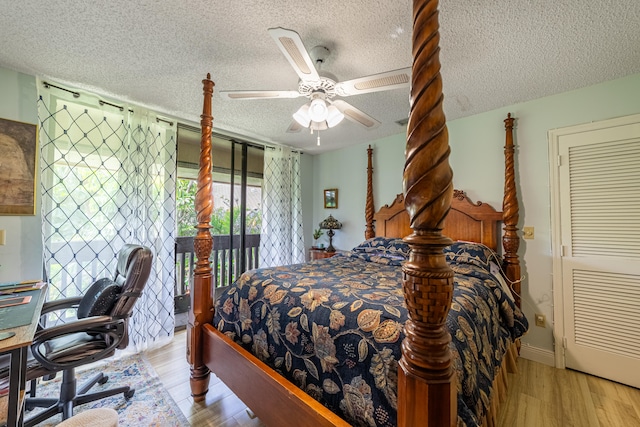 bedroom featuring a ceiling fan, access to outside, light wood-style flooring, and a textured ceiling