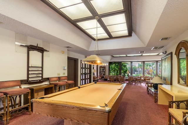 game room with carpet, a raised ceiling, visible vents, pool table, and a textured ceiling