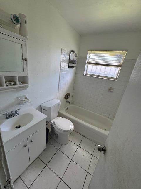 full bathroom with vanity, tile patterned floors, toilet, and tiled shower / bath