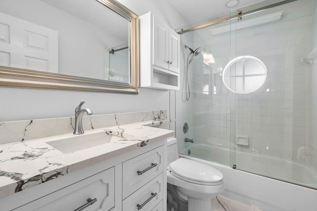 full bathroom with toilet, combined bath / shower with glass door, and vanity