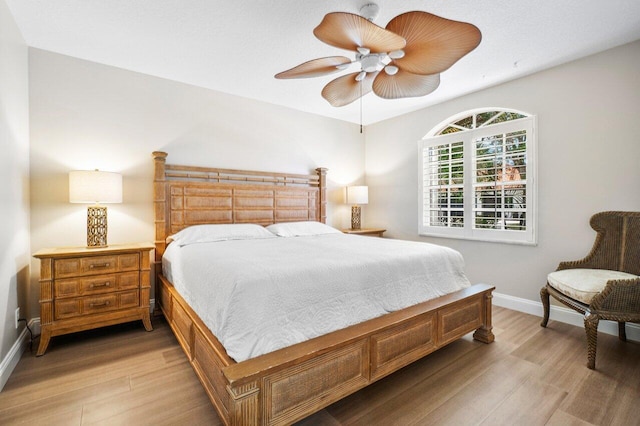 bedroom with ceiling fan and light hardwood / wood-style floors