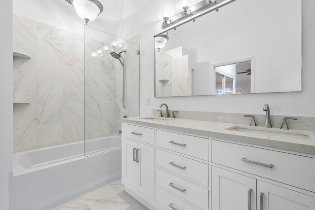 bathroom featuring tiled shower / bath and vanity