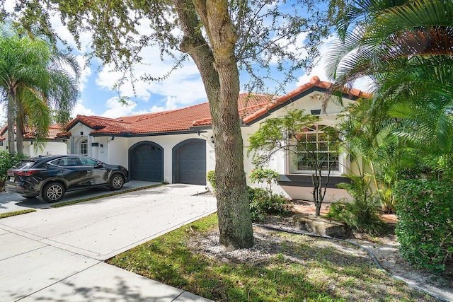 mediterranean / spanish home featuring a garage