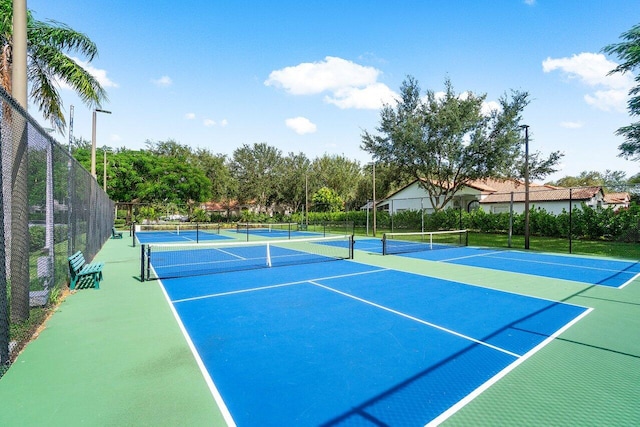 view of tennis court featuring basketball hoop