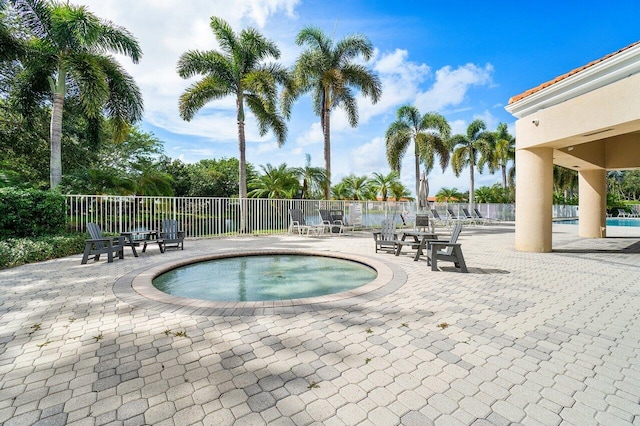 view of pool featuring a hot tub and a patio area