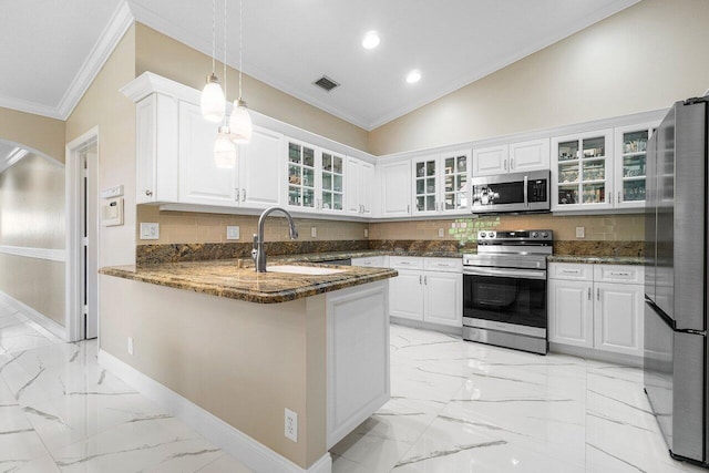 kitchen with white cabinets, dark stone countertops, kitchen peninsula, and appliances with stainless steel finishes