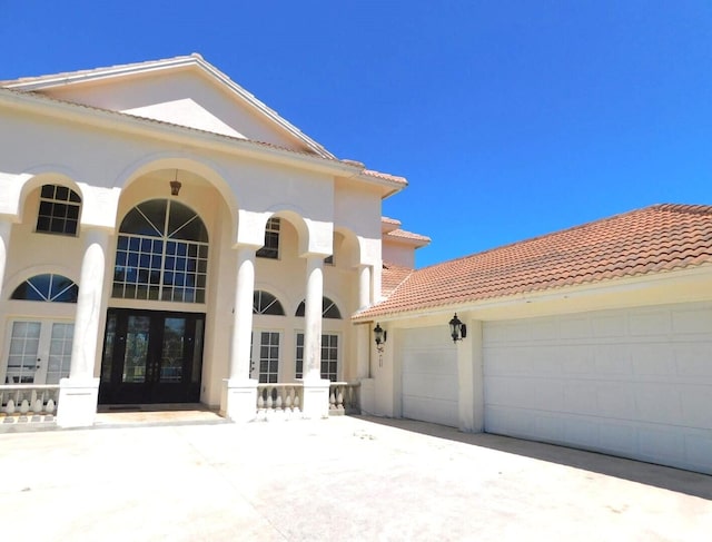 view of front facade featuring french doors and a garage