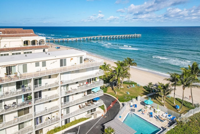 bird's eye view with a water view and a beach view