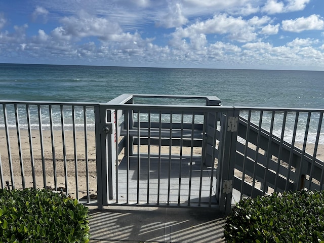 exterior space featuring a water view and a beach view