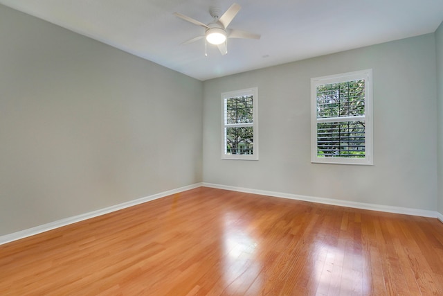 unfurnished room with ceiling fan and light wood-type flooring