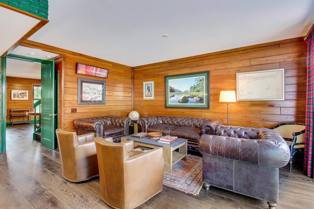 living room with hardwood / wood-style flooring and wooden walls