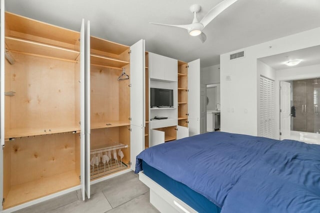 bedroom featuring ensuite bath, ceiling fan, and light tile patterned flooring