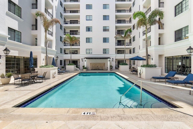 view of swimming pool featuring a patio area