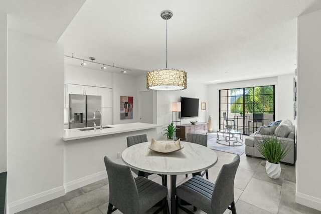 dining area with sink and track lighting