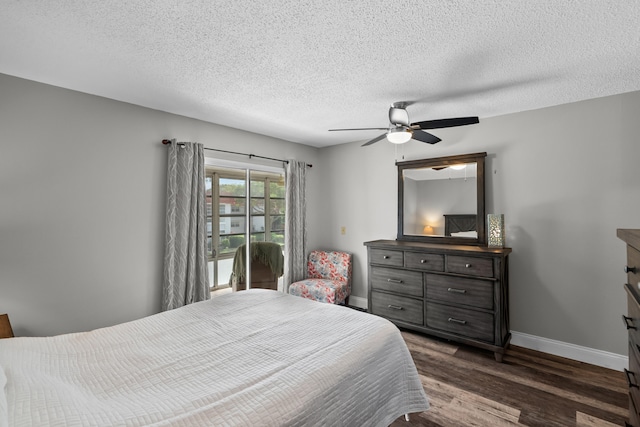 bedroom with ceiling fan, dark hardwood / wood-style floors, and a textured ceiling