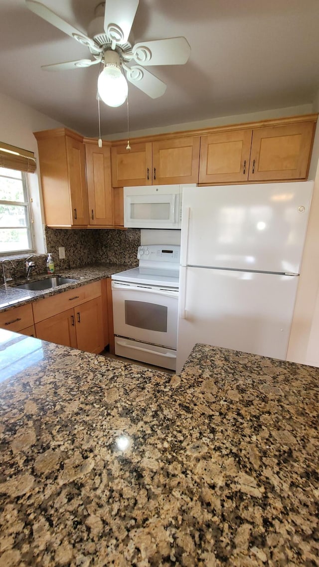 kitchen with sink, white appliances, backsplash, and ceiling fan