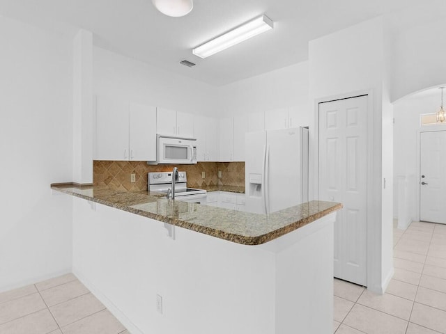 kitchen with white cabinetry, white appliances, kitchen peninsula, and tasteful backsplash