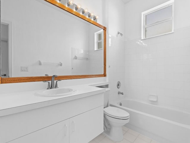 full bathroom with tile patterned floors, vanity, tiled shower / bath combo, and toilet