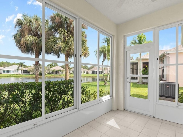 unfurnished sunroom with a healthy amount of sunlight and a water view