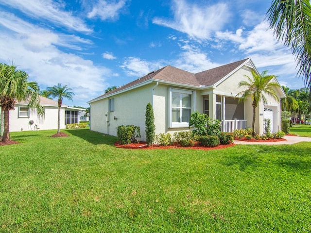 view of side of property with a garage and a lawn