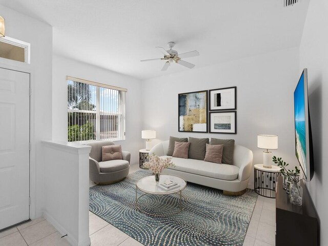 tiled living room with ceiling fan