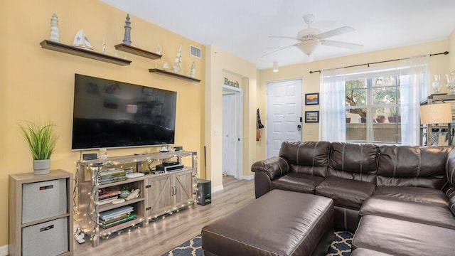 living room with ceiling fan and light hardwood / wood-style flooring