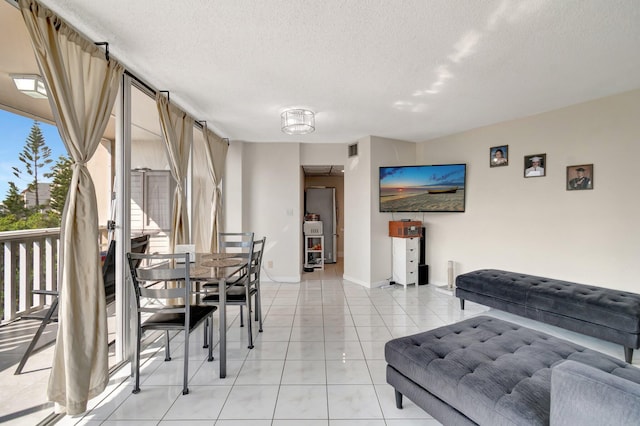 interior space with light tile patterned floors and a textured ceiling